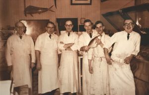 Historic photo of butchers inside a butcher shop large