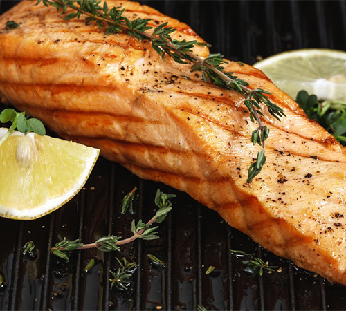 Grilled salmon with rosemary and lemon on the grate