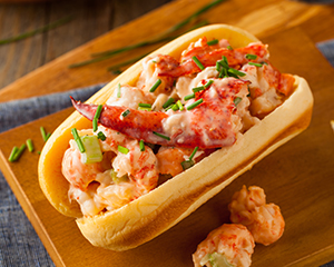 Tasty lobster roll sandwich on the wooden board