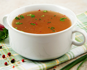 Chicken stock in white bowl