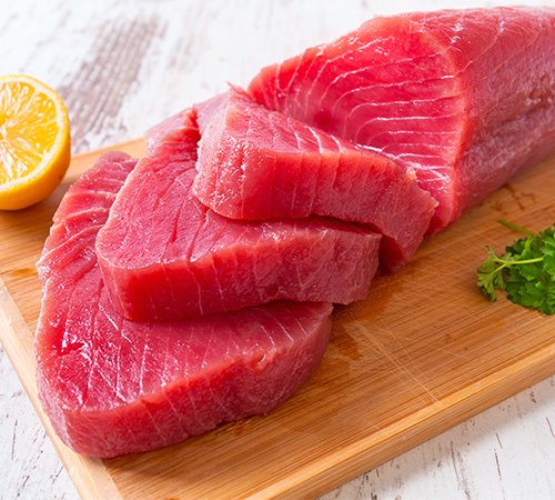 Fresh tuna sliced on wooden board
